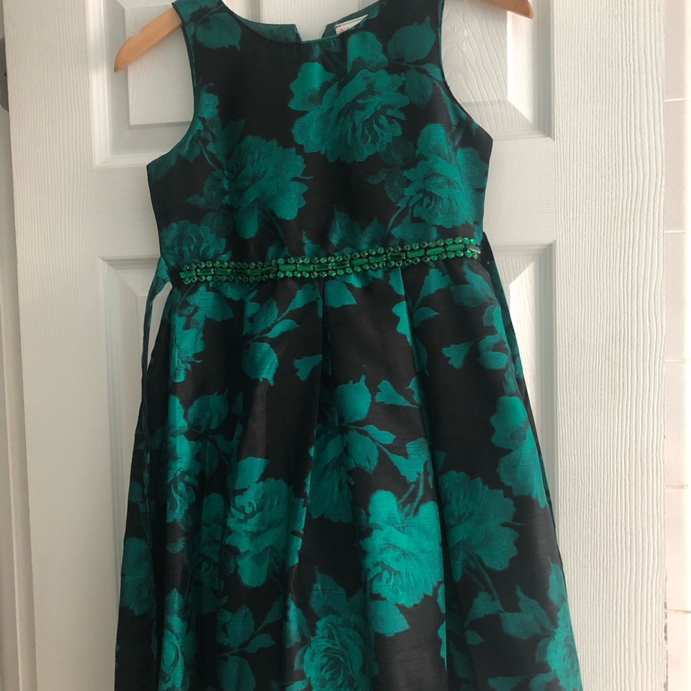 Girls fancy dress. Hi-low hem. Pretty emerald gemstones at waist, back bow.
